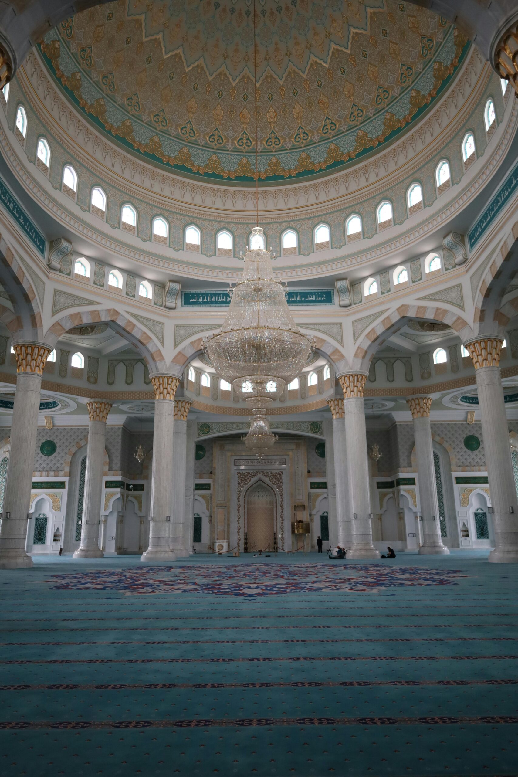 A breathtaking view of the Hazrat Sultan Mosque interior with a grand chandelier and detailed architecture.